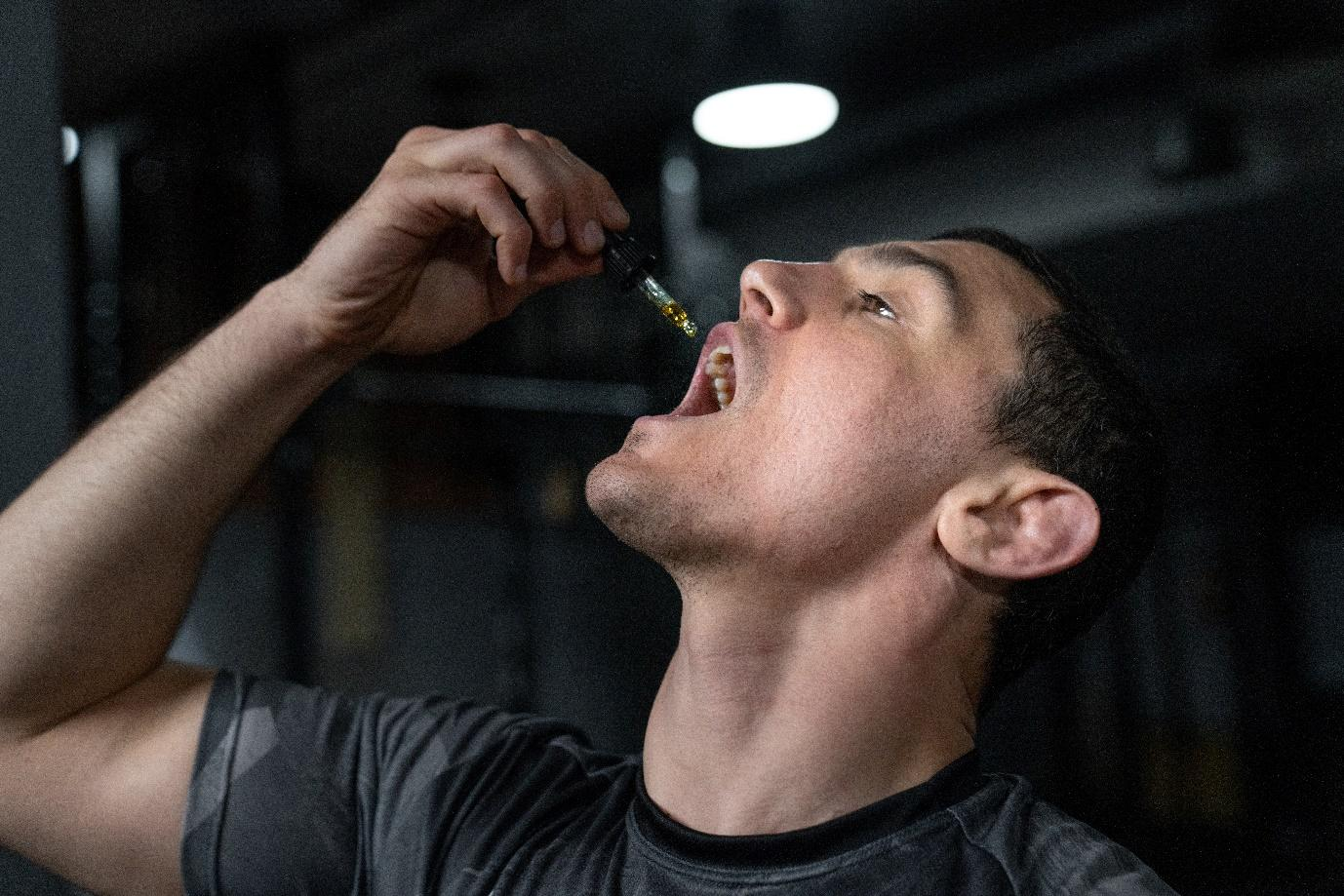 A man using CBD oil tincture
